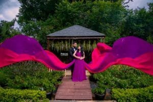 Couple framed by flowing fabric during an outdoor photoshoot