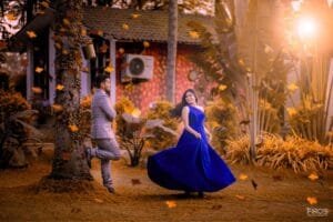 Couple posing outdoors with autumn-style effects and golden light