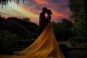 Romantic couple silhouette photographed against a colourful sunset