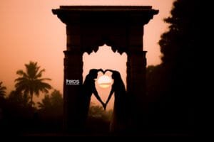 Romantic couple silhouette forming a heart during sunset