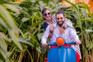 Couple riding a colourful scooter during a fun pre-wedding photoshoot