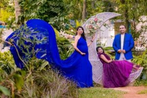Family maternity portrait with decorative crescent moon backdrop