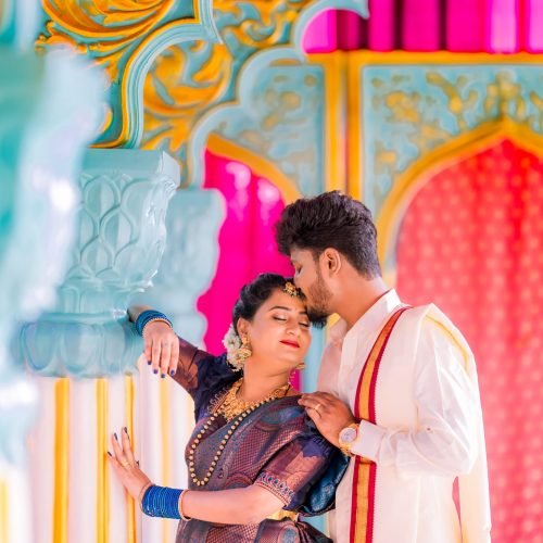 Traditional couple photographed at a colourful Bangalore resort setting