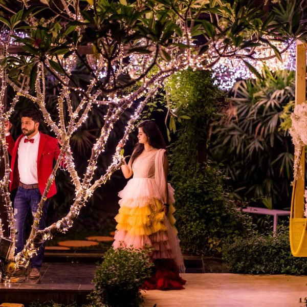 Couple posing beneath illuminated trees during a resort pre-wedding shoot